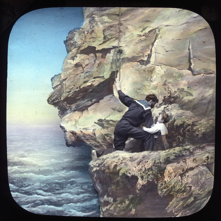 man on rocks with child