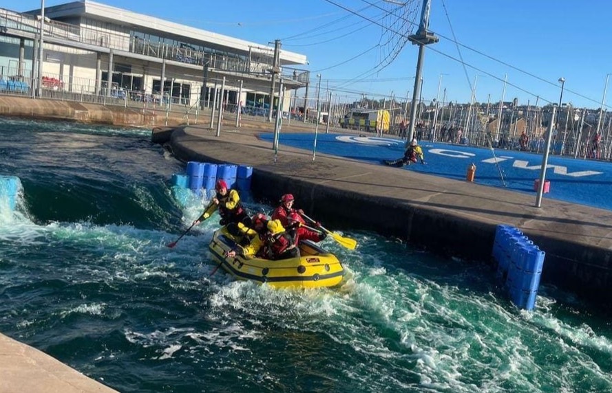 Emergency services navigate a rib down a rapids course