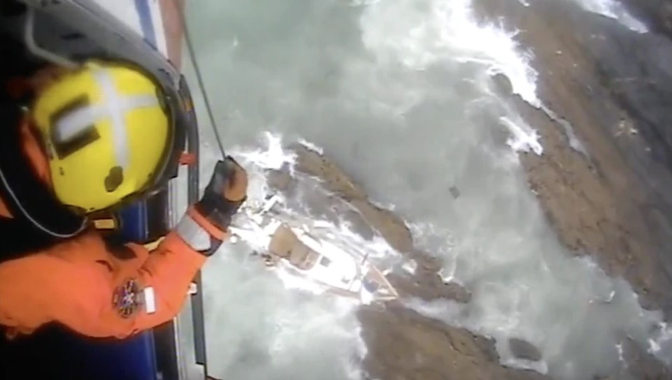 Abi Wild winching aboard a stricken vessel at Salcombe