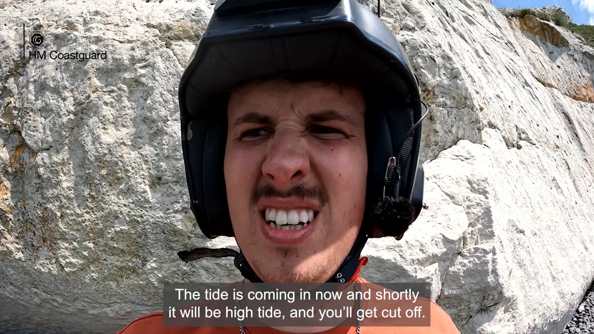 Musician and Comedian Arthur Hill climbs a cliff with help from an HM Coastguard Rescue Team. 