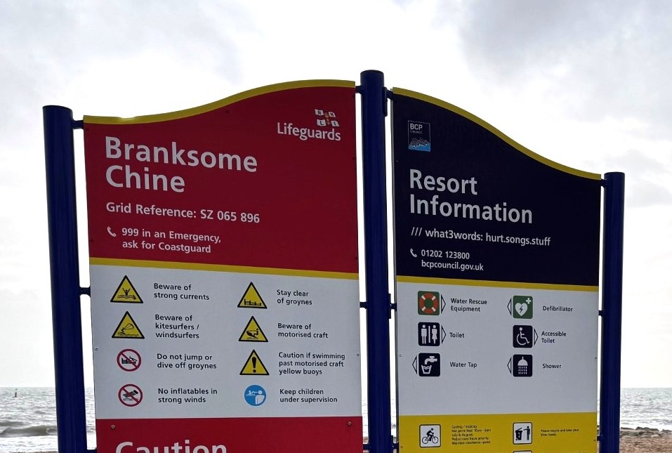 close up of a read and blue beach safety sign