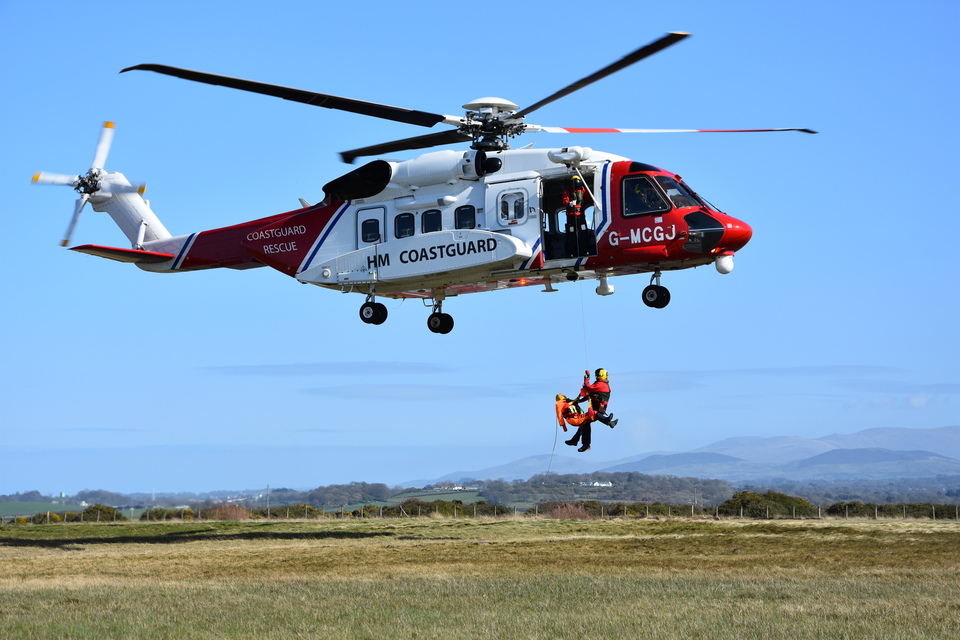 An HOM Coastgaurd search and rescue helicopter practices with a winchman