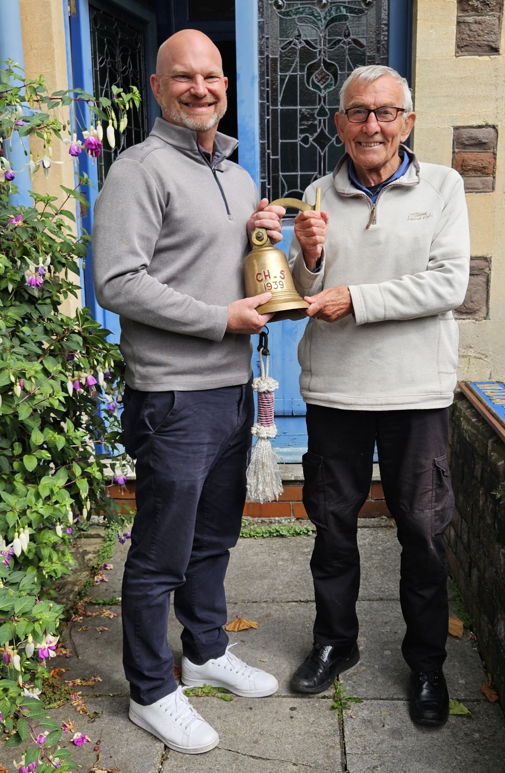 Receiver of Wreck Steve White and diver Anthony Reed together holding the Carentan's ship's bell