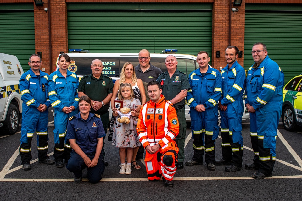 Donna with one of her children, alongside HM Coastguard and ambulance staff who worked together to save her life. Credit: Yorkshire Ambulance Service