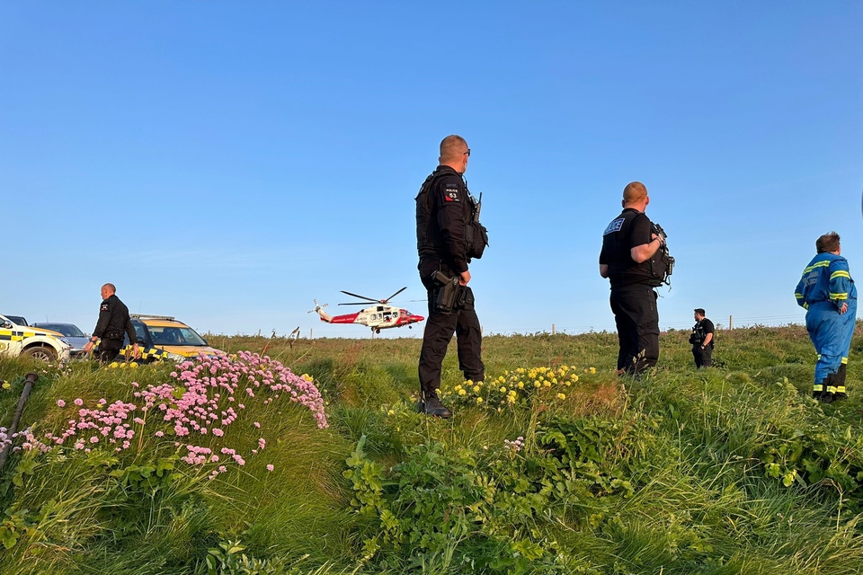 Emergency services and helicopter on clifftop at Bassets Cove, Portreath