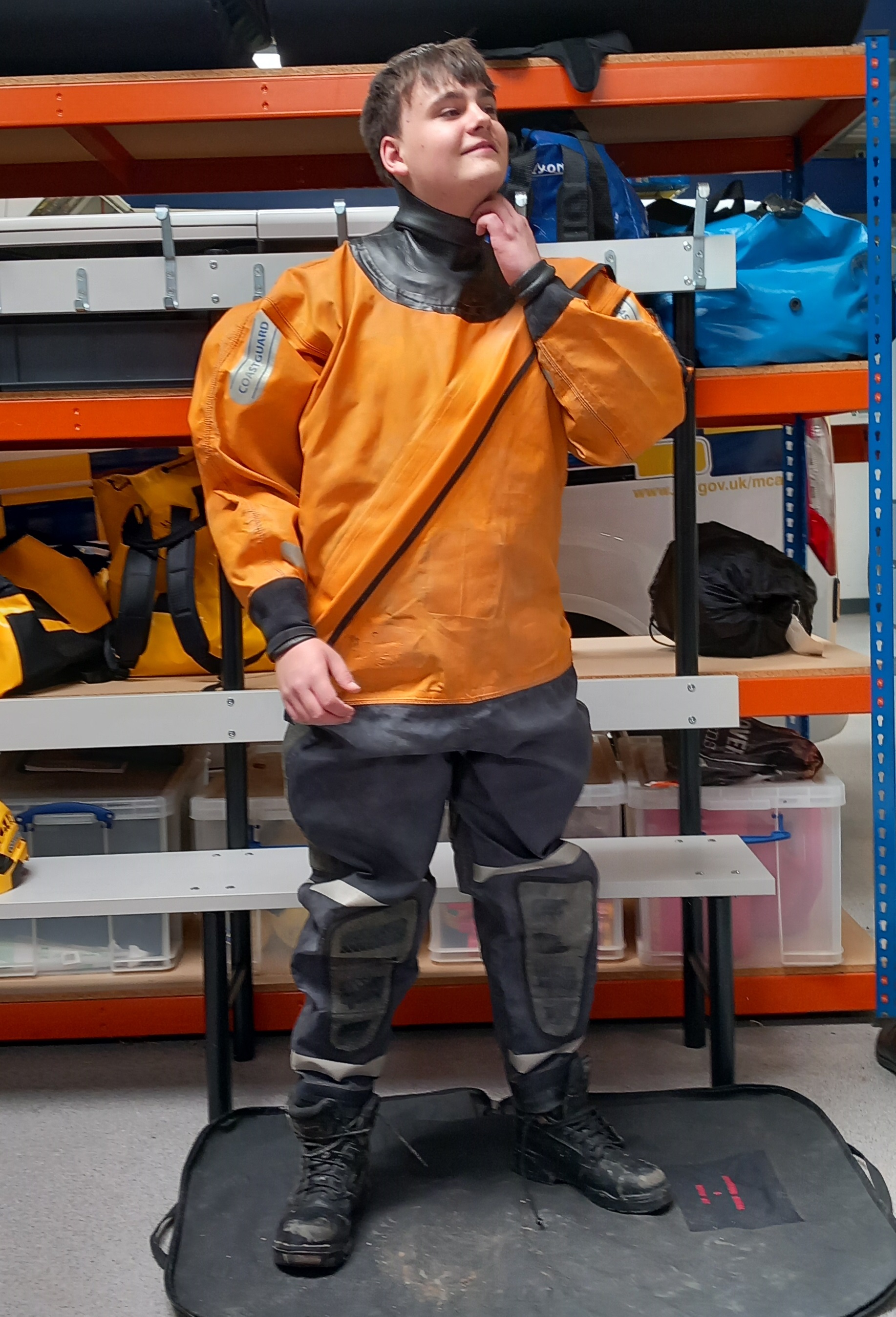 Work experience student Felix Palmer tries on Coastguard Rescue apparatus