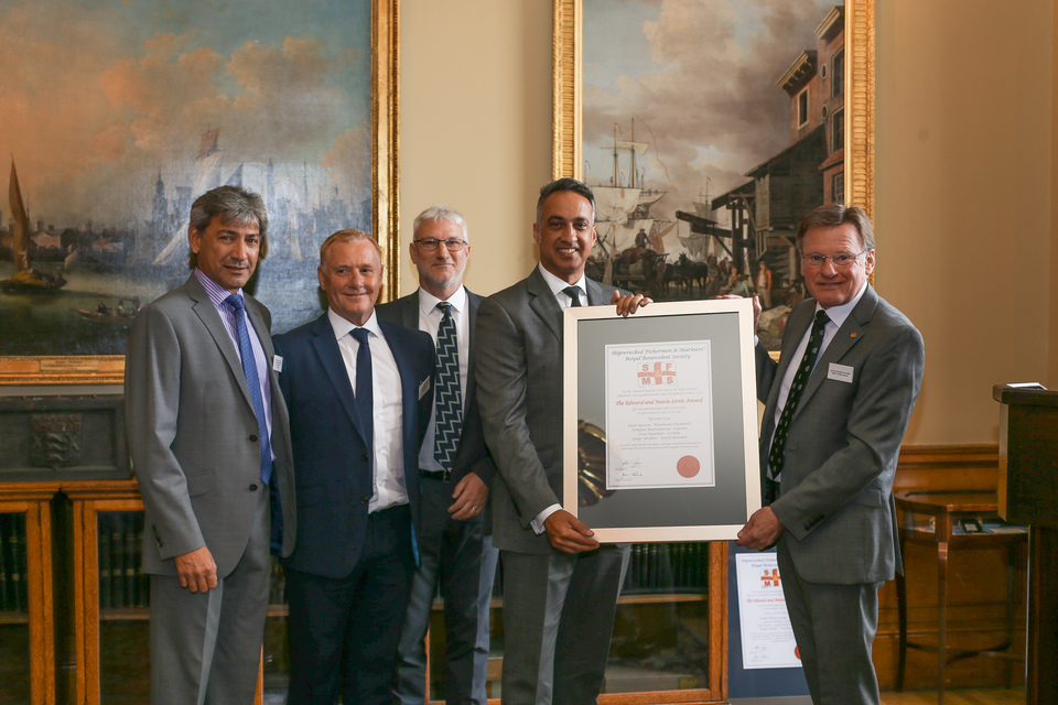 The HM Coastguard crew of the Newquay helicopter which carried out the Church Cove rescue in 2020, being presented with the 2021 Edward and Maisie Lewis Award by Captain Ian McNaught, Deputy Master of Trinity House