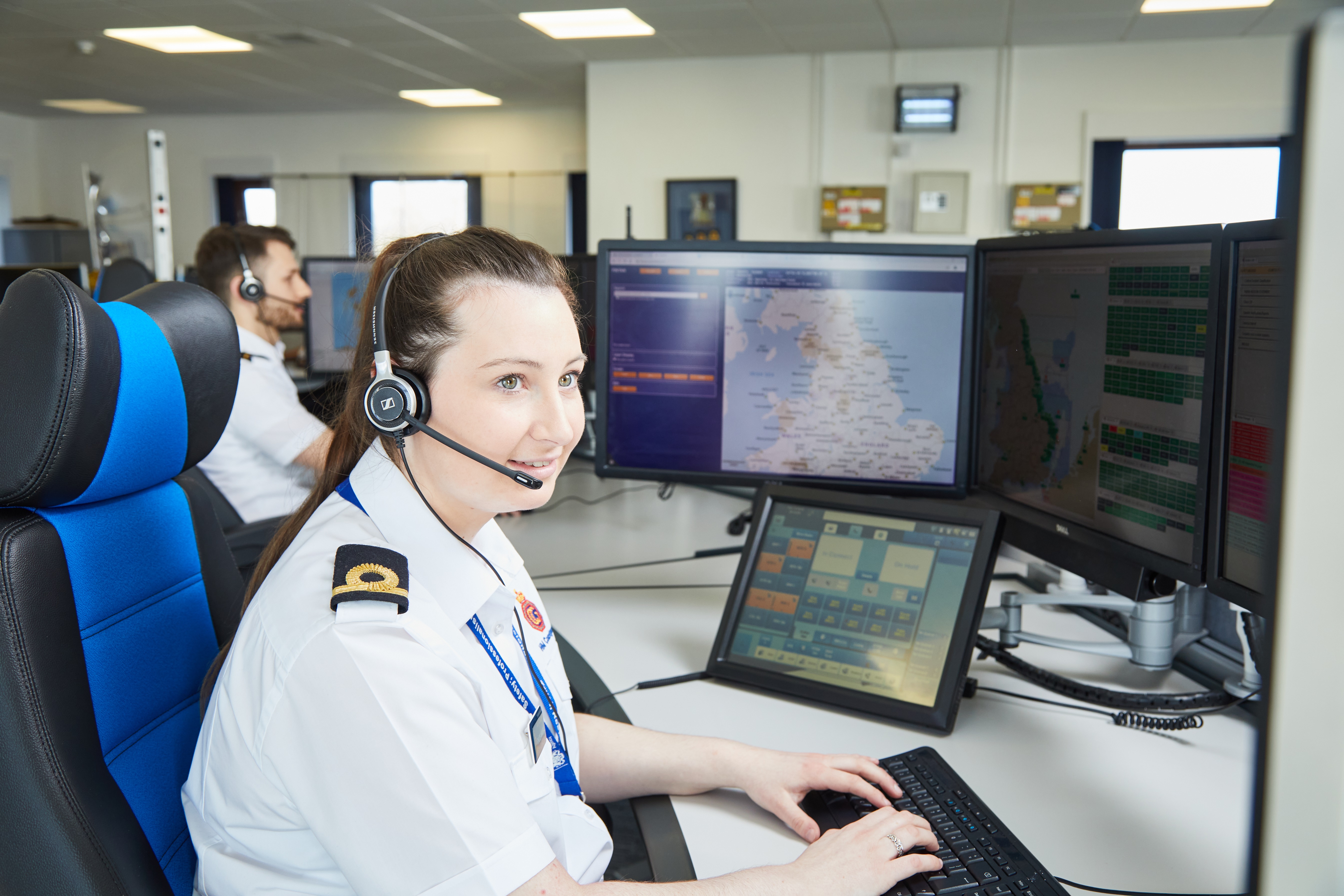 An HM Coastguard operations room officer at a computer terminal