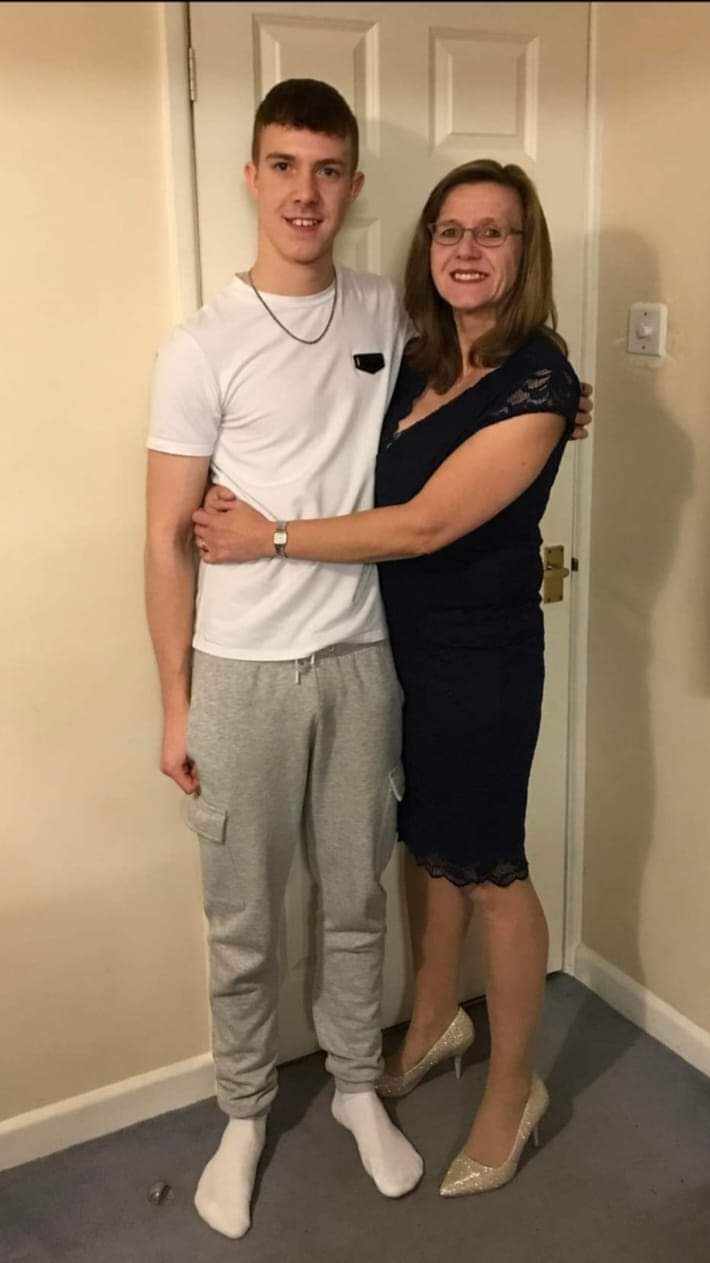 Joe Abbess standing next mum Vanessa Abbess as she hugs him