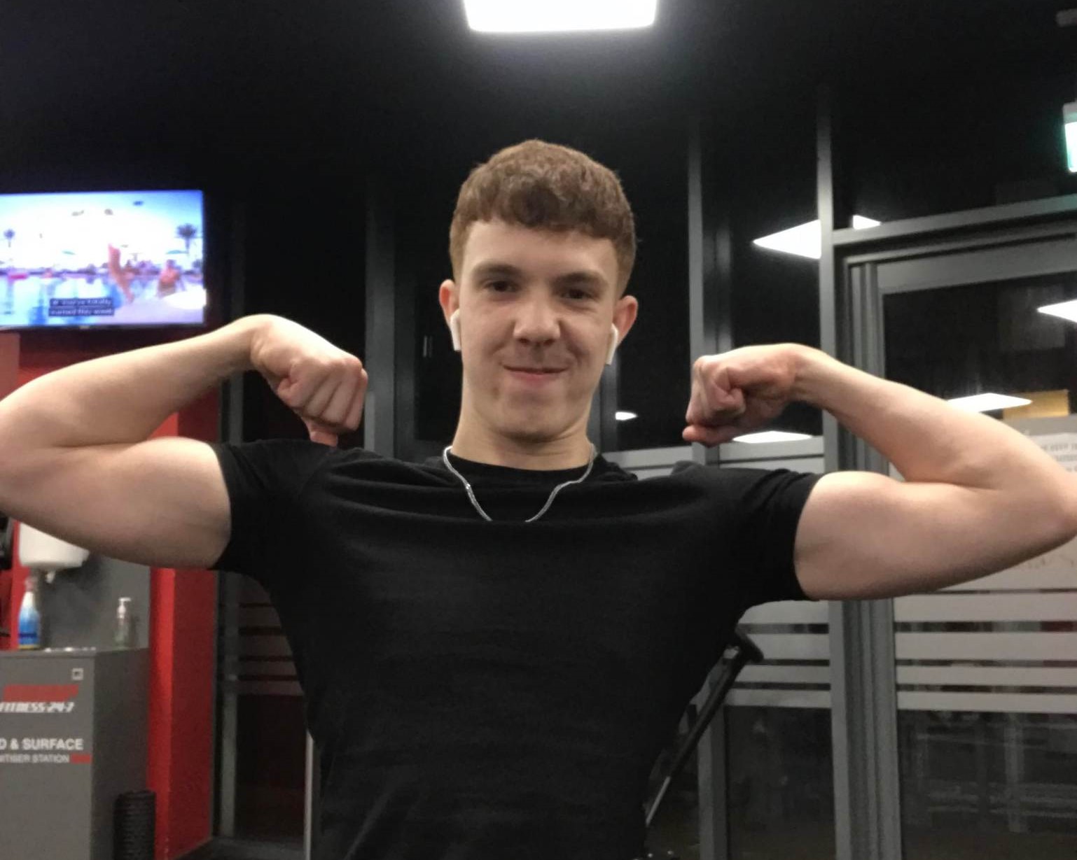 Joe Abbess in the gym flexing his muscles