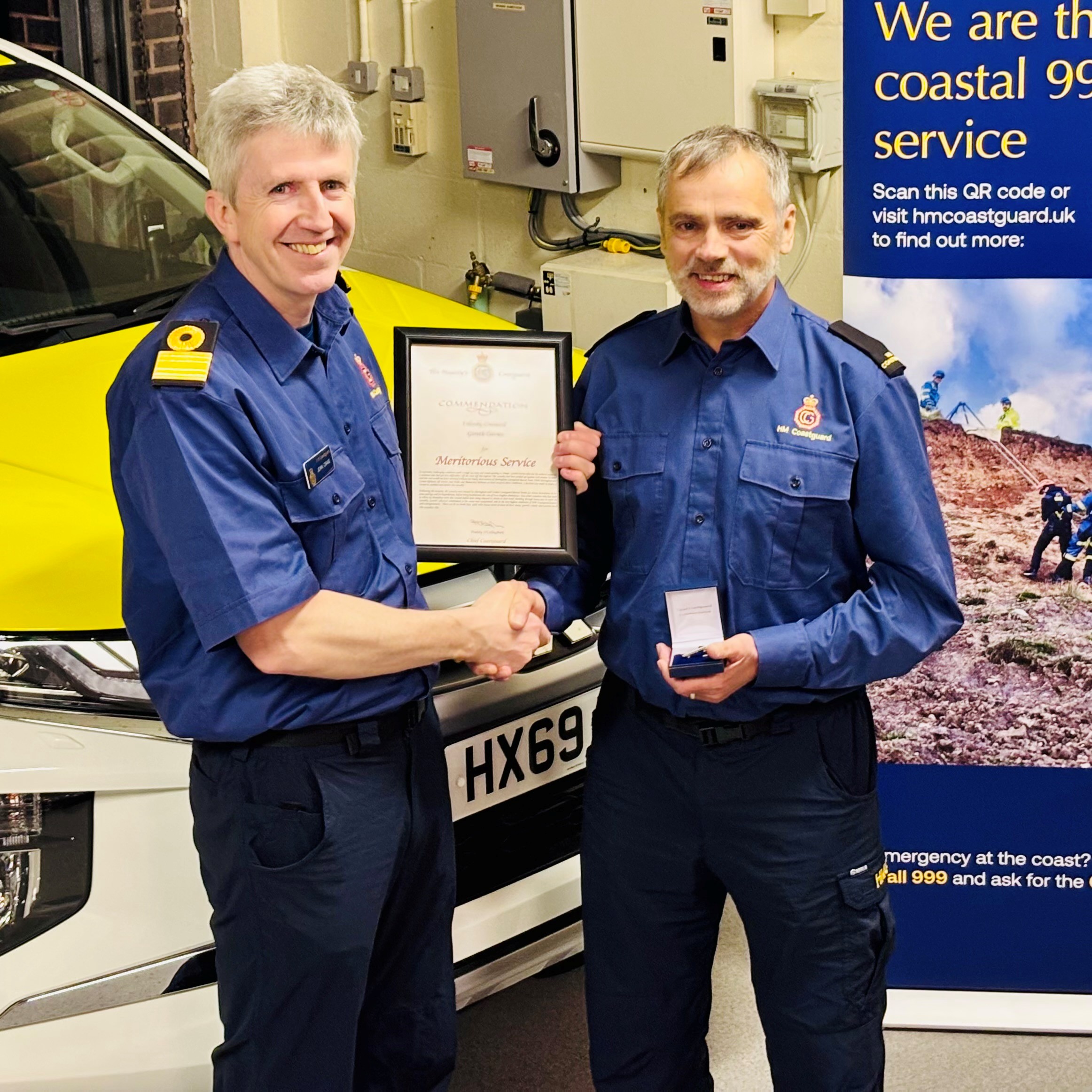 John Craig (left) presents the Commendation to Gareth Davies