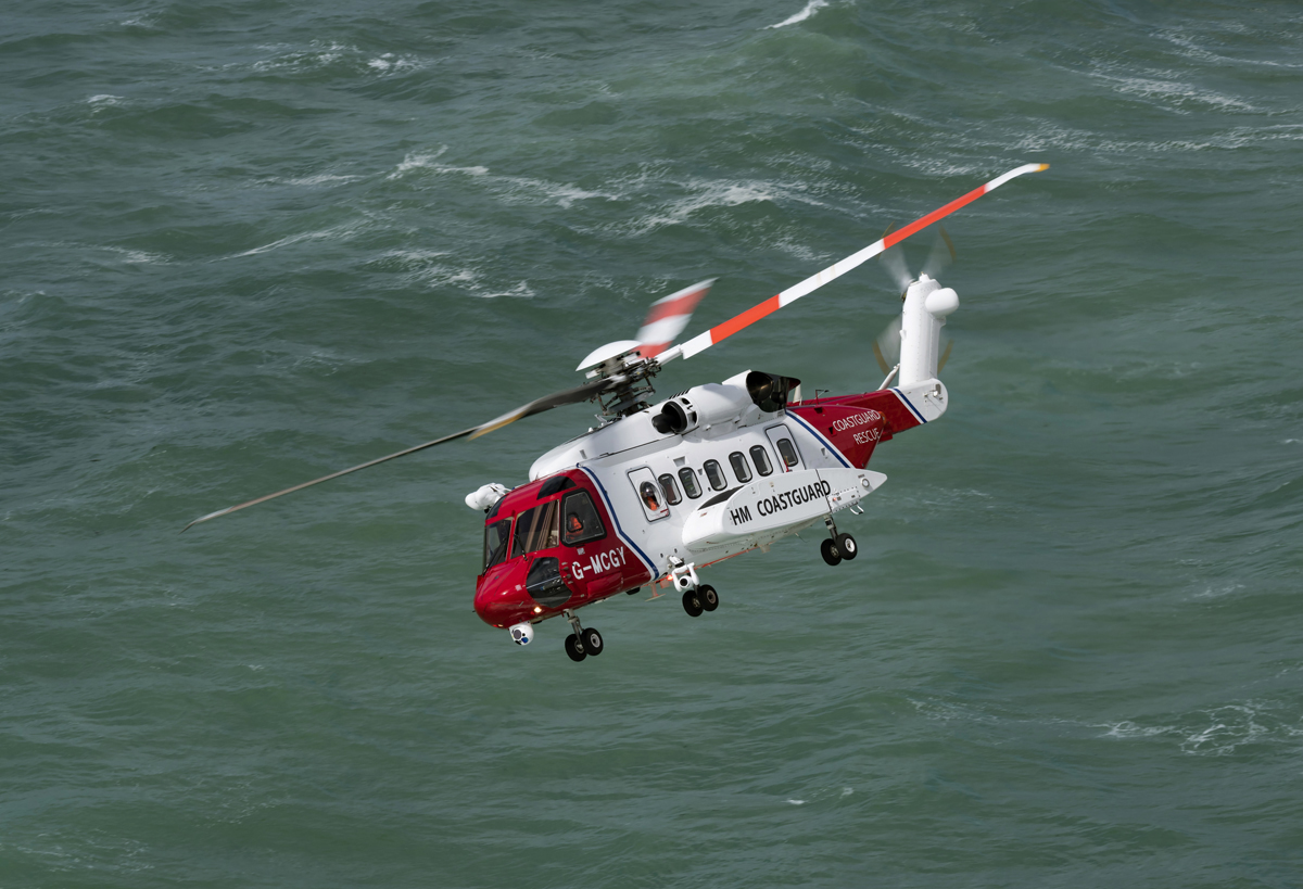 An HM Coastguard search and rescue helicopter flying above the sea