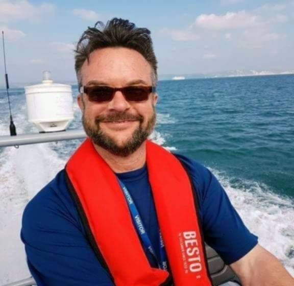 Paul Tunstall wearing a lifejacket on a boat