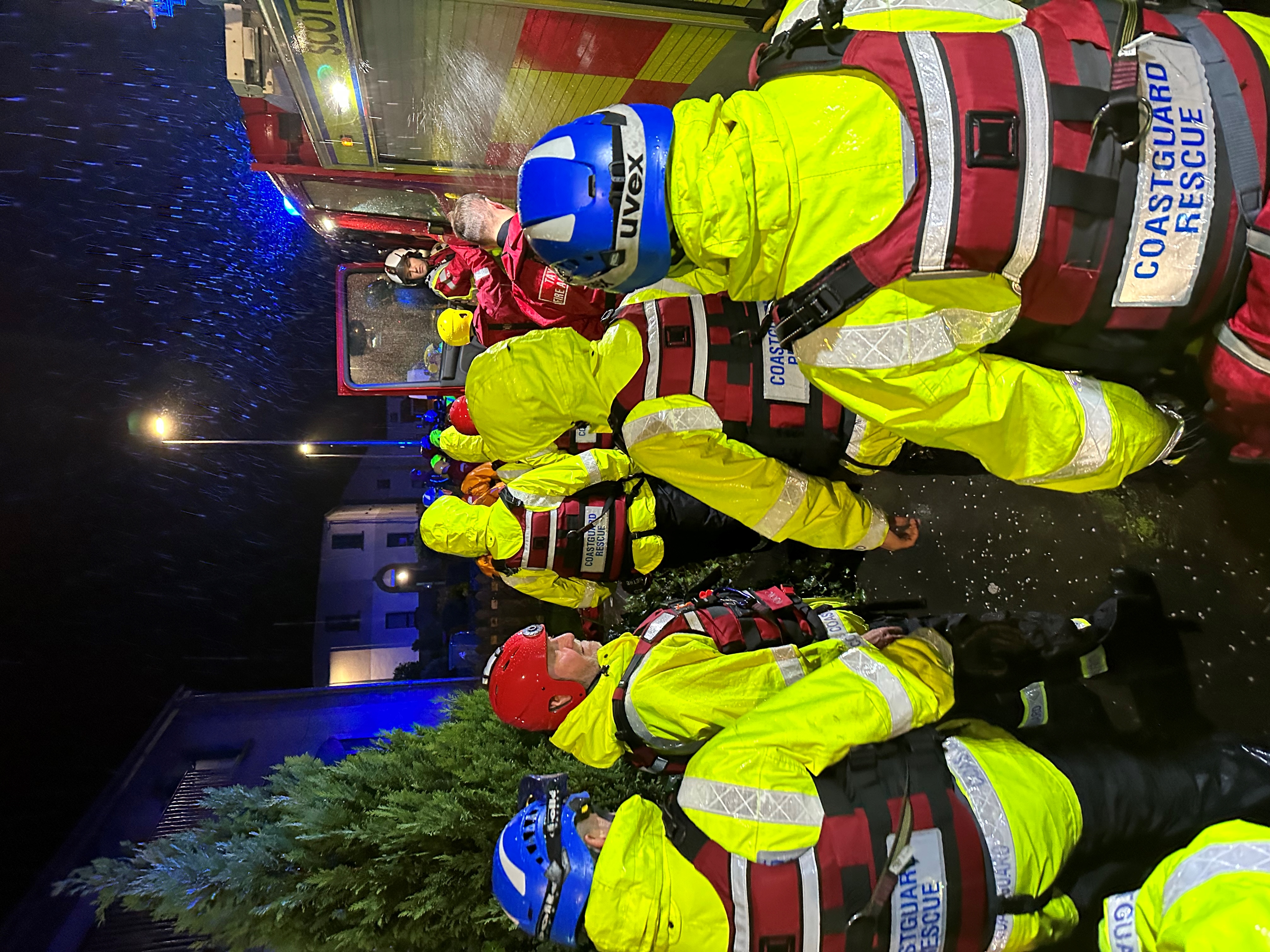 Coastguard rescue officers muster in preparation for flood response in the dark