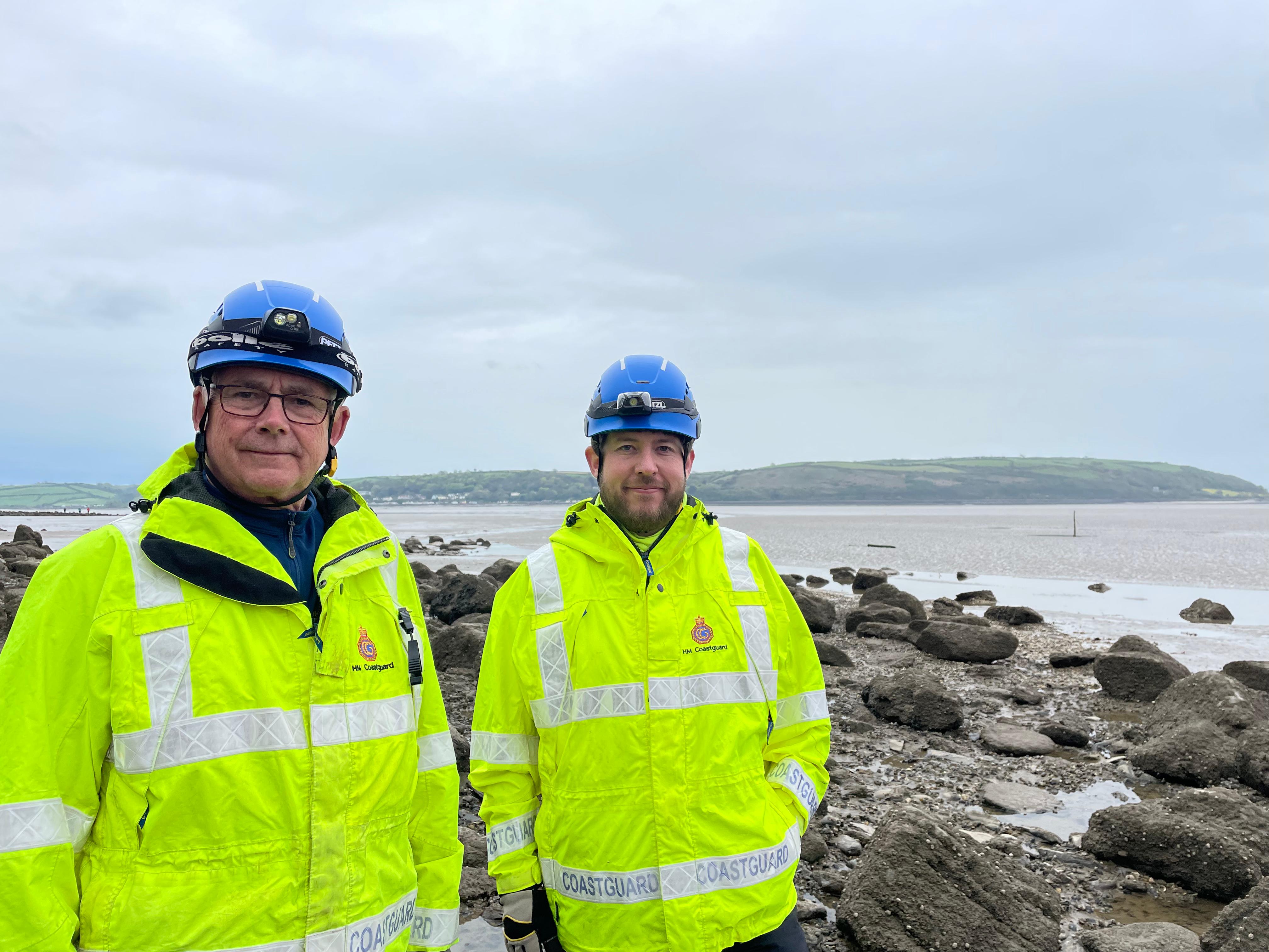 Chris (left) and Gwyn in high vis jackets at the rocky coastline