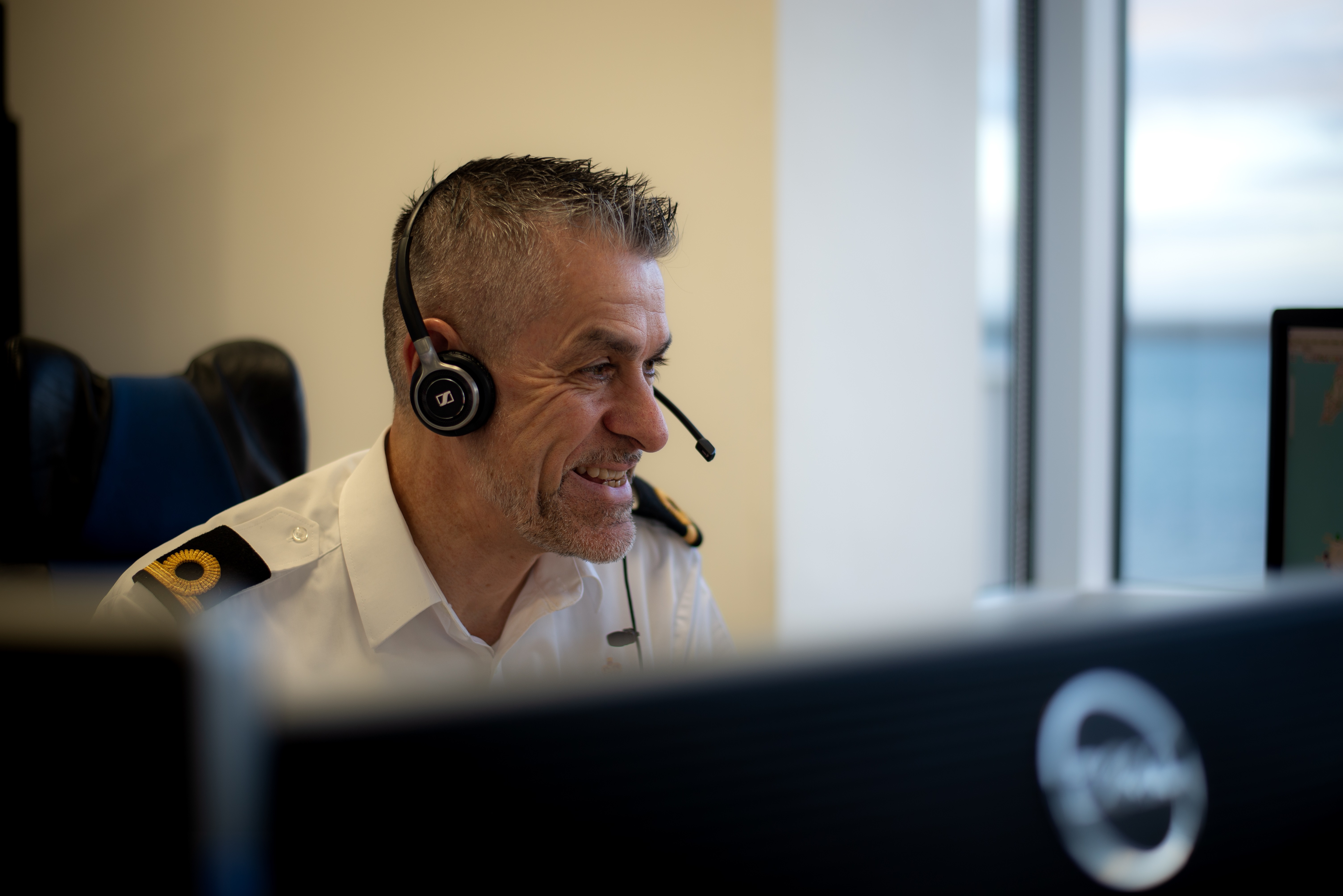 Richard Brighton, Maritime Operations Officer, at a computer terminal