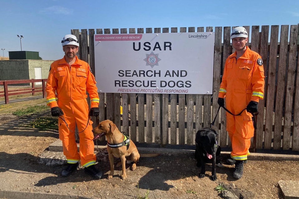 Ryan Gray and colleague with specially trained dogs