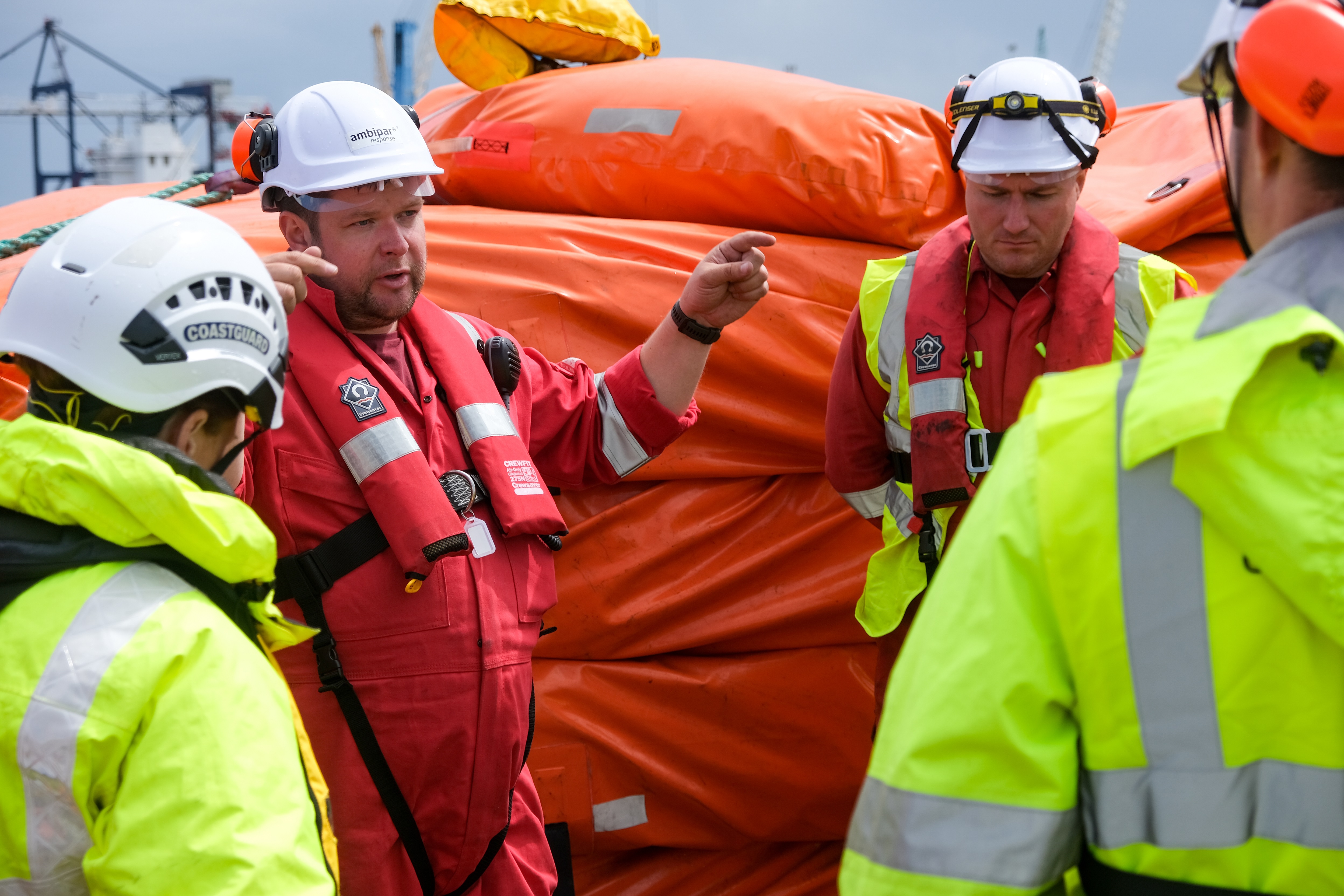Personnel discuss the exercise in front of equipment