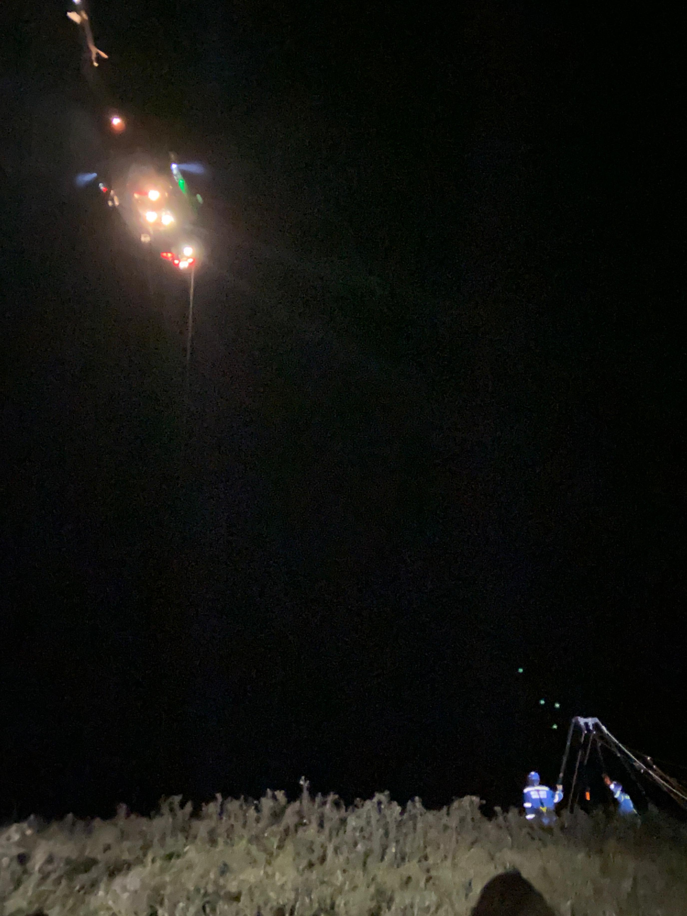 Helicopter getting into position alongside the cliff