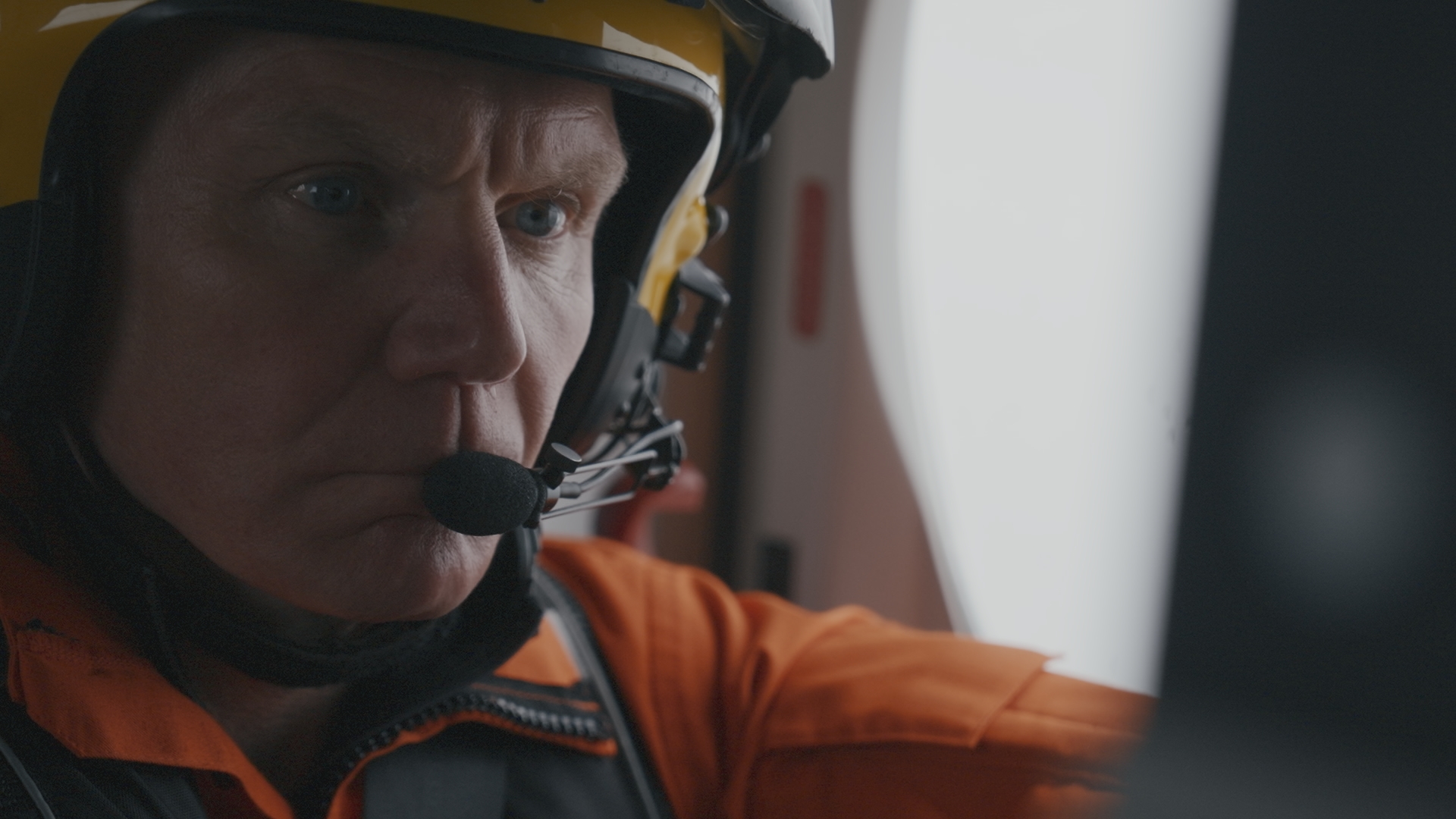 Winch Paramedic Chris Bradshaw inside an HM Coastguard helicopter