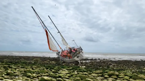 Vessel aground on chalky beach