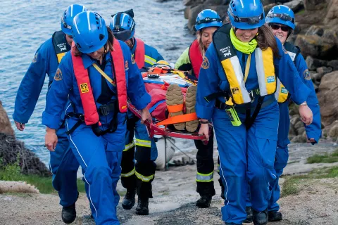 An HM Coastguard Rescue Team extricates a casualty from a coastal location 
