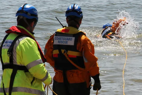 Coastguard rescue officers practice a water rescue