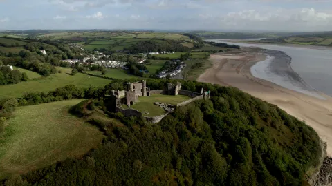 Aerial view of a coastal estuary with sand and a castle