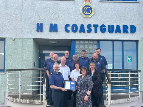 Coastal Operations Area Commander Murdo Macaulay and NHS Western Isles Chief Operating Officer Frances Robertson with HM Coastguard officers at Stornoway MRCC