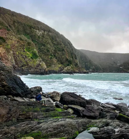 The craggy outcrop of Lee Beach is seen with tide crashing against the rocks and no obvious sign of exit 