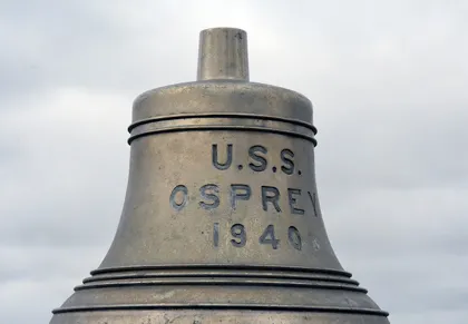 A metal bell with the words U.S.S. Osprey 1940 engraved on it