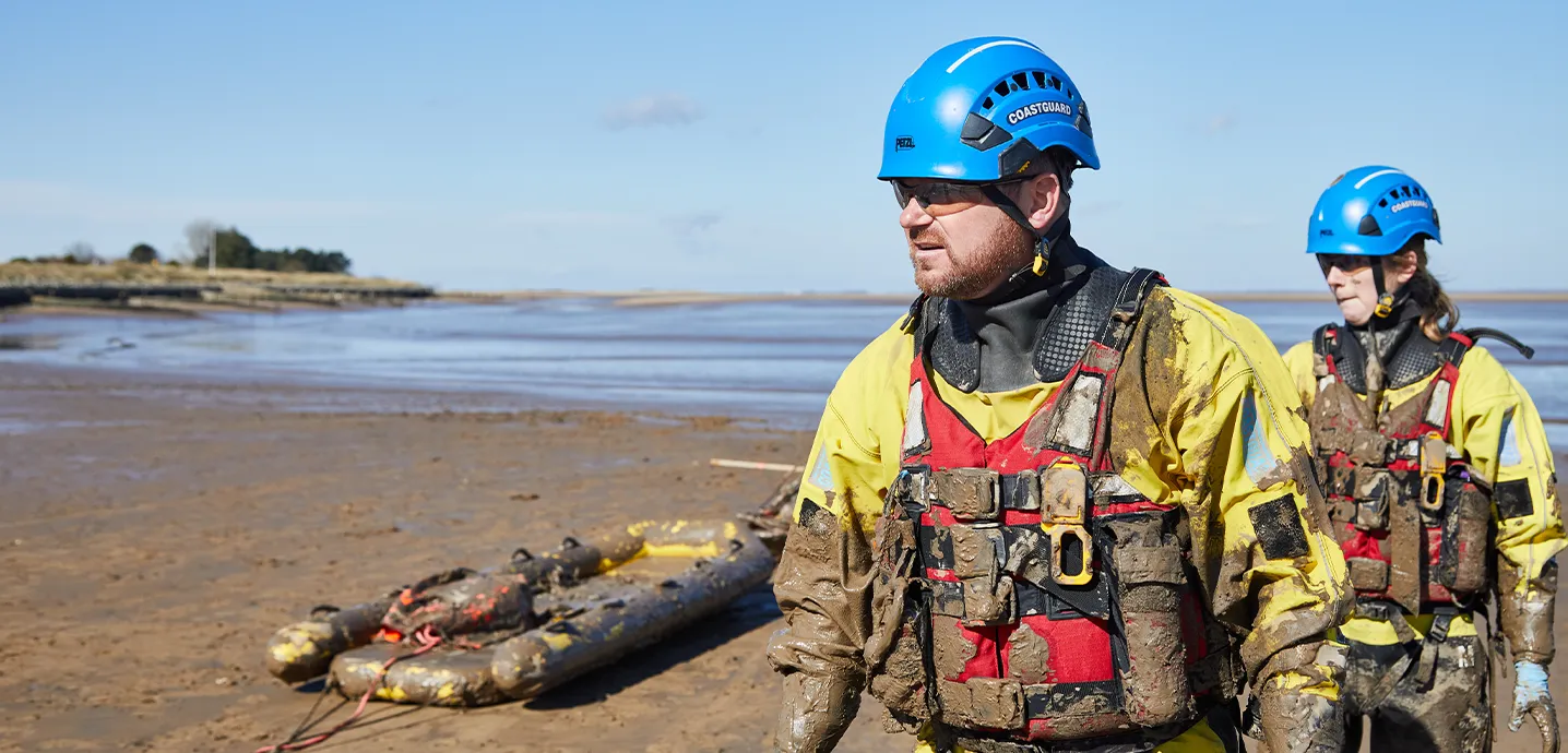 Two coastguards returning from a mud rescue