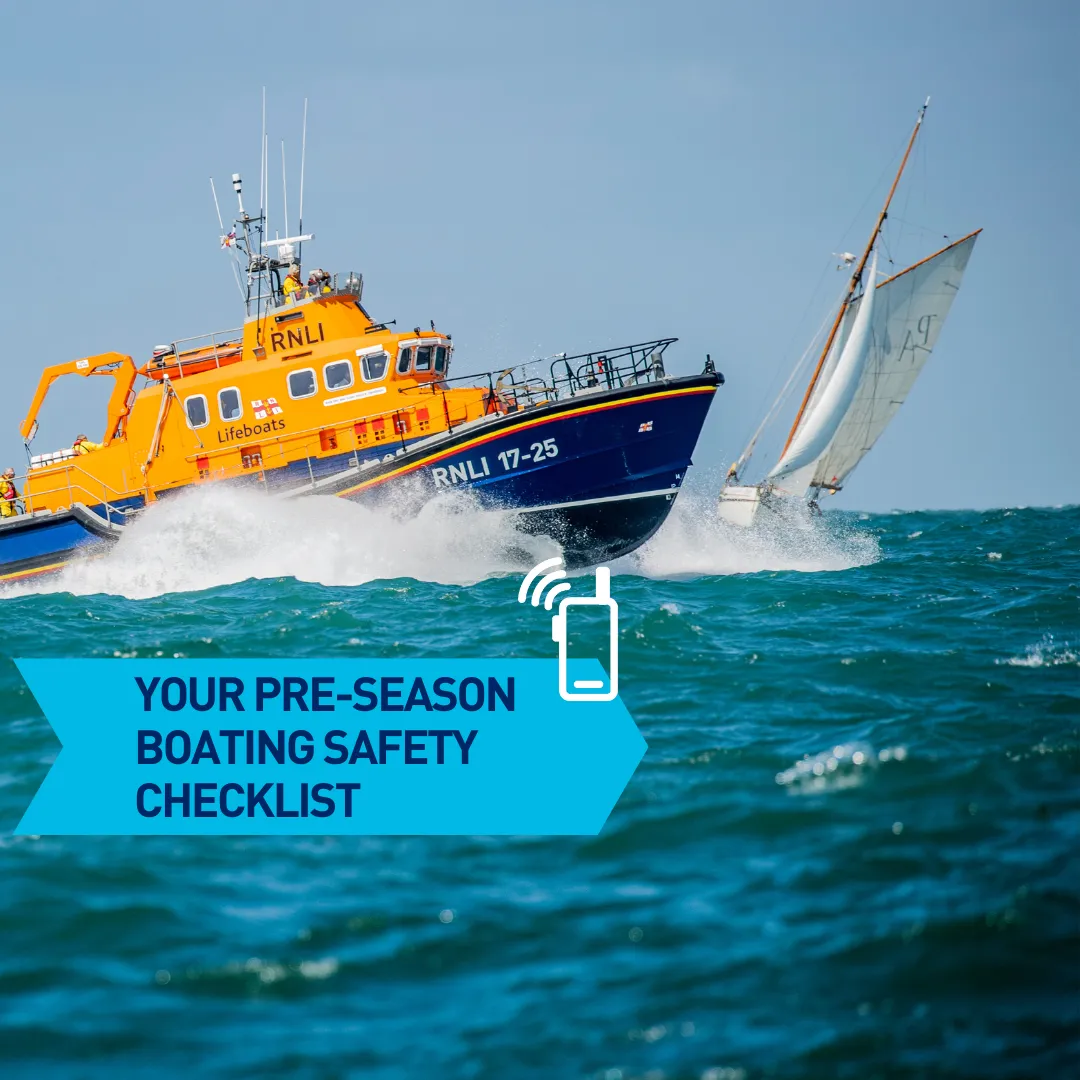 An RNLI lifeboat is approaching a sailing vessel. Text reads - 'Your pre-season boating safety checklist'