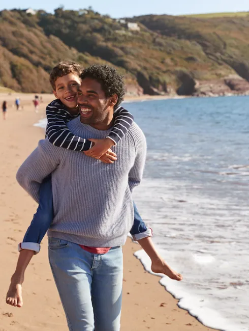 man on beach with child