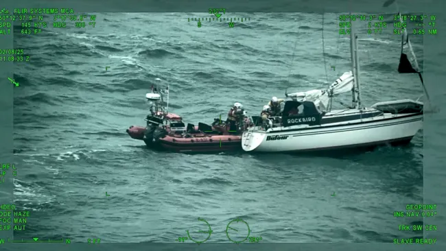 An RNLI lifeboat rescuing Richard Spreckley from his vessel during rough sea conditions