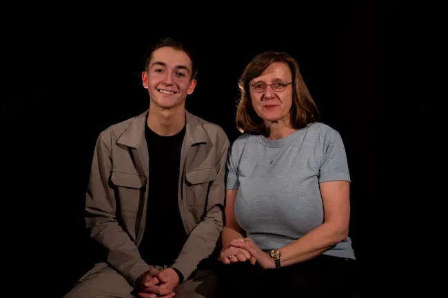 Joe Green and Vanessa Abbess sat next to one another against a plain, dark background